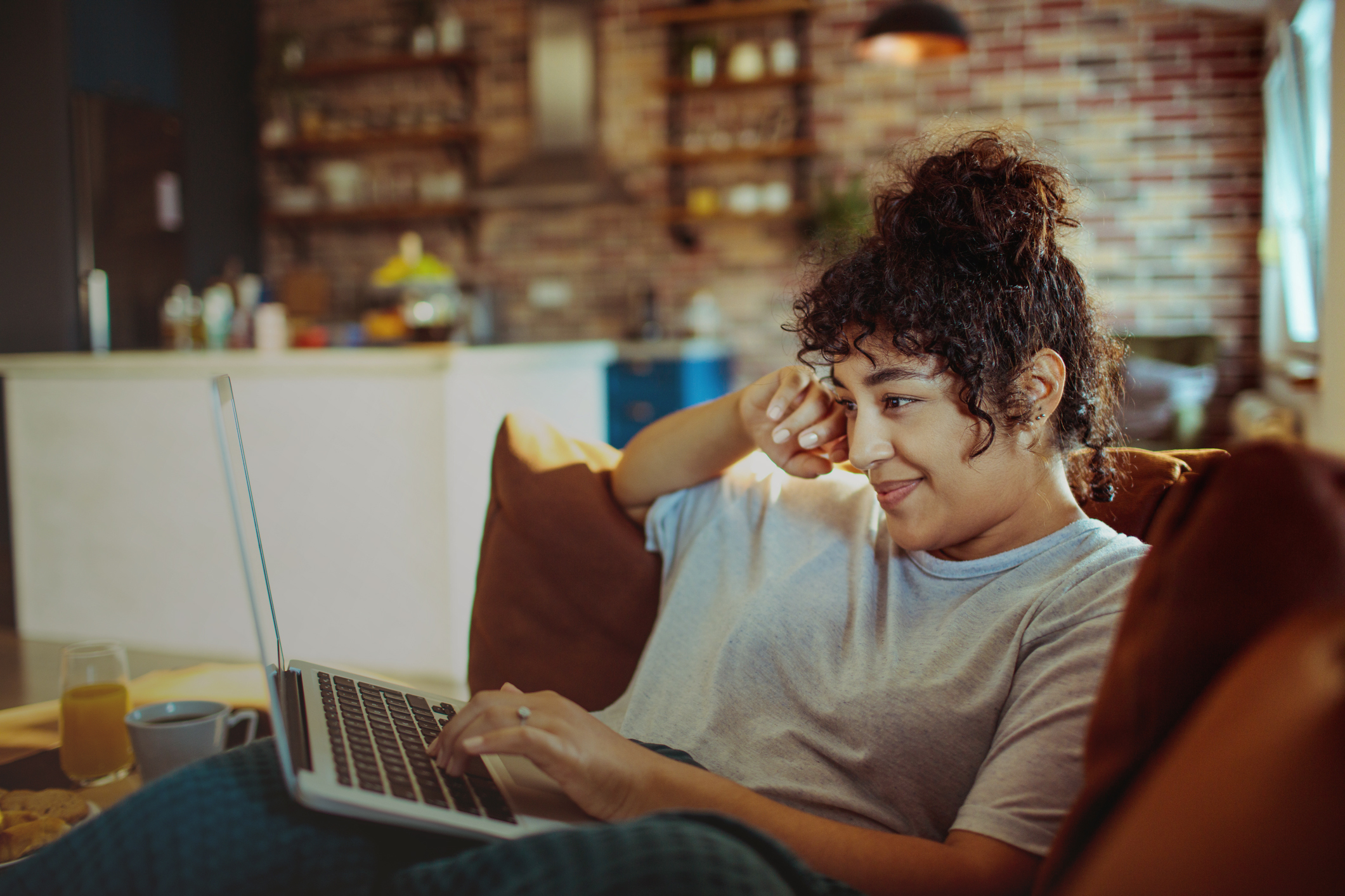 Close up of a young woman using a laptop at home