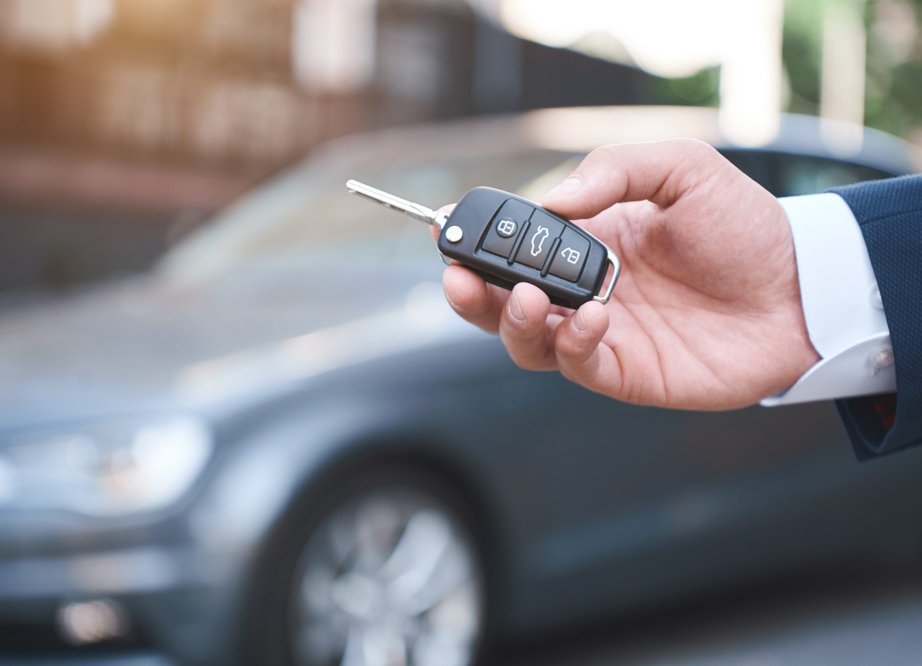 Dreams Come True. Young man holds the keys to a new car