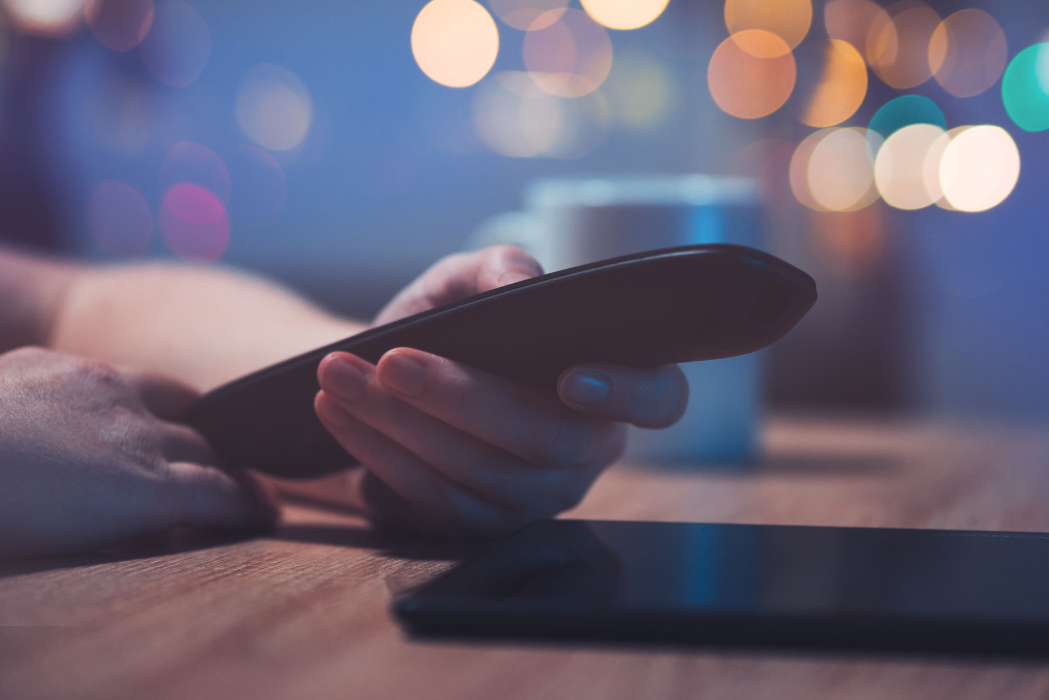 Female hand with television remote control pointing to tv set and turning it on or off or changing channels, selective focus (Female hand with television remote control pointing to tv set and turning it on or off or changing channels, selective focus,