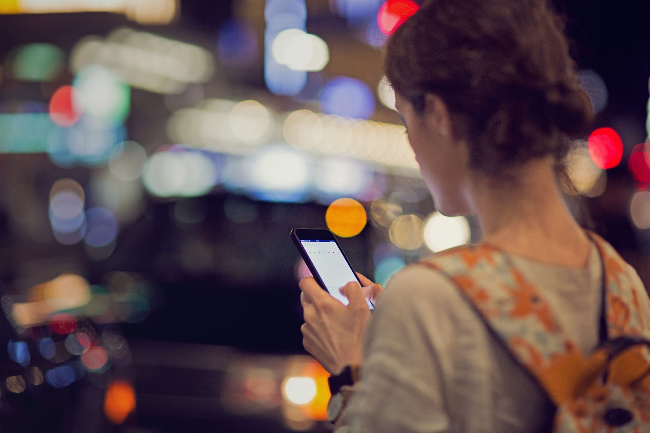 Young Caucasian girl is searching for her directions in Tokyo till her mobile is almost without battery.