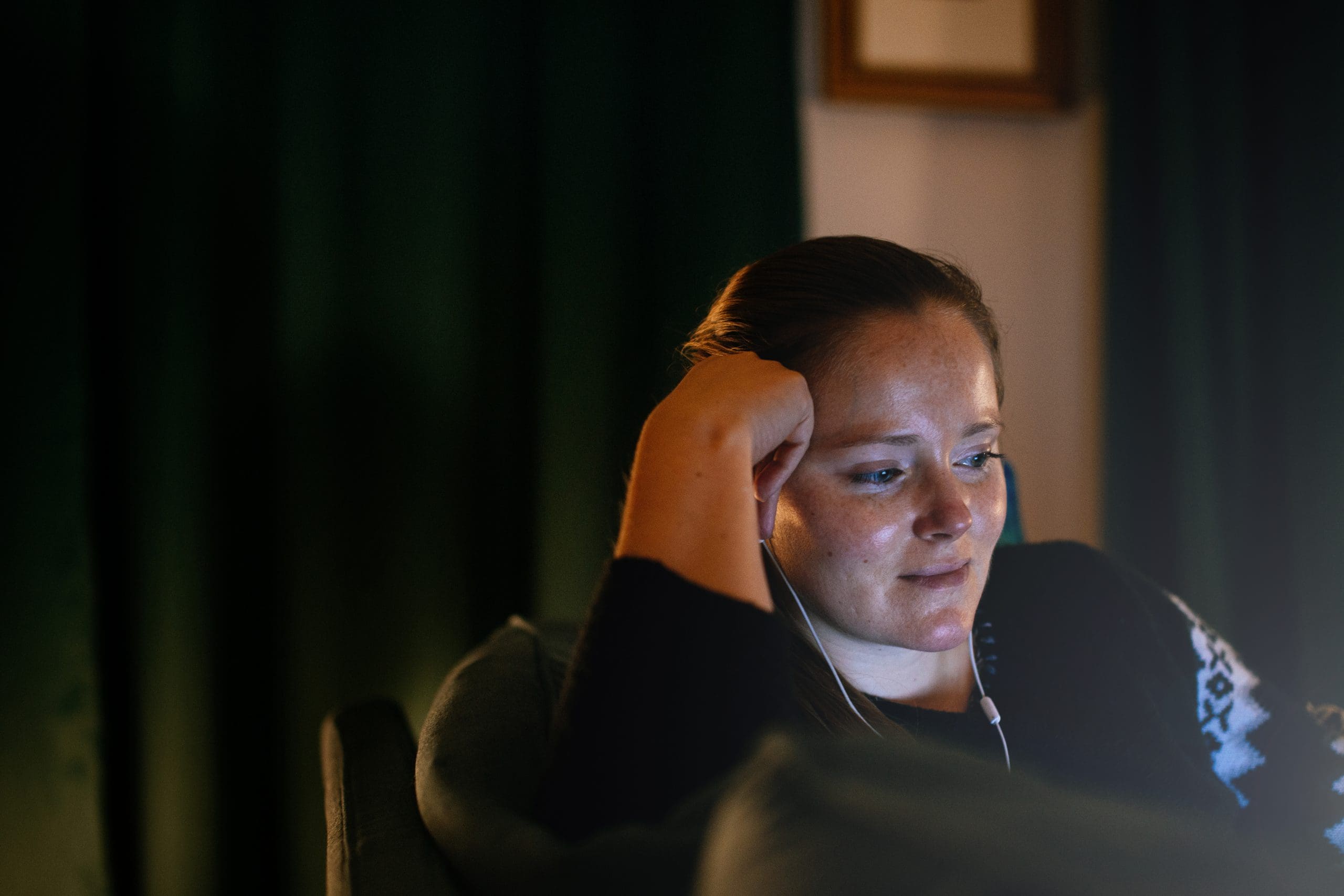 Woman watching movie at night at home.